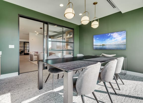 Conference room with long table and glass sliding door at luxury apartment in Woodbury