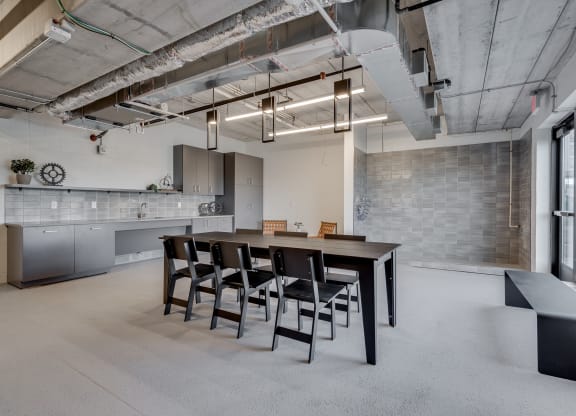 Room with concrete flooring and subway tiled walls and various seating areas at Aspire at CityPlace