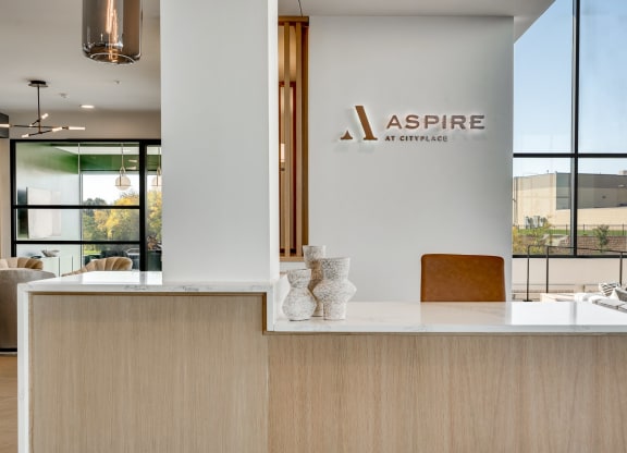 Front desk with white quartz counter in the main lobby at Aspire at CityPlace in Woodbury MN