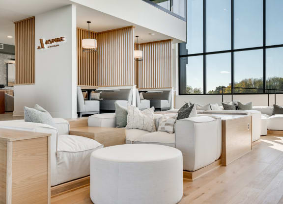 Couch seating and built in booth areas with full-wall windows in the lobby at Aspire at CityPlace
