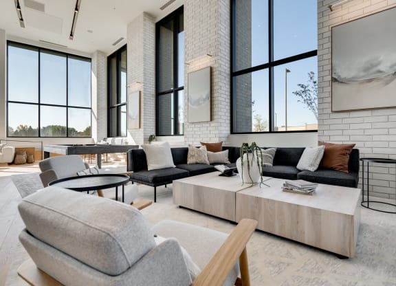 Couch seating area with large coffeee table in the center in the lobby at Aspire luxury apartments 55125