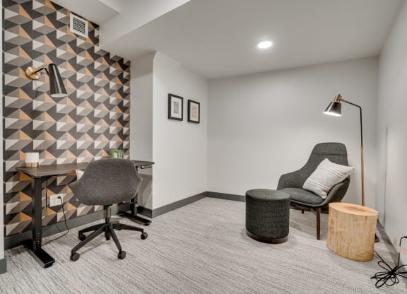 Luxury work from home suite equipped with adjustable desk and separate seating area