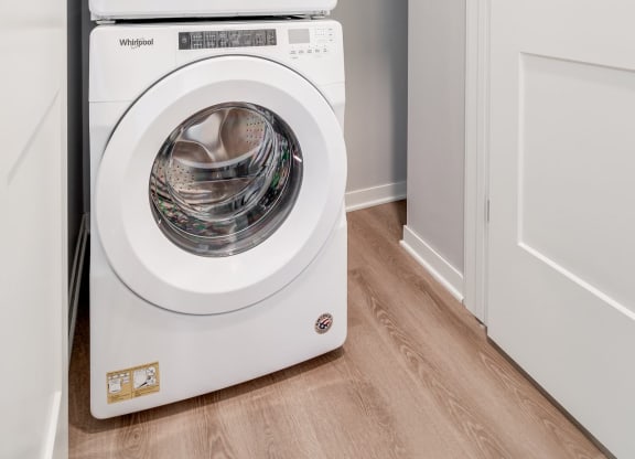 Stacked front loading washer and dryer in a closet at Aspire at CityPlace in Woodbury MN 55125