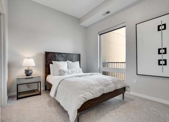 Bedroom with high ceiling and large window in two bedroom luxury apartment Woodbury MN 55125