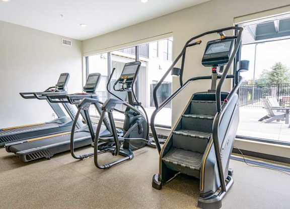 a 24-hour fitness center with treadmills, ellipticals, and a Stairmaster