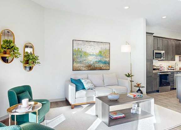 a furnished living room with midcentury modern furniture and plenty of natural light