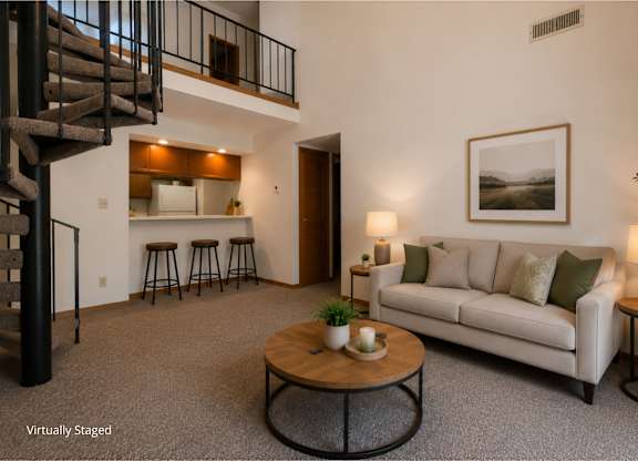 Two-story apartment living room with a loft layout, carpeted flooring, a spiral staircase, open breakfast bar with seating, and a spacious living area with modern furnishings.