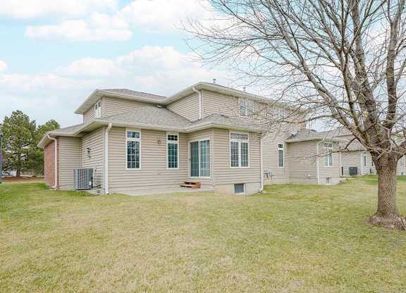 the back yard of a duplex with a patio space