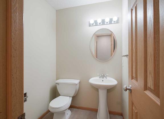 a half bathroom with a sink and toilet