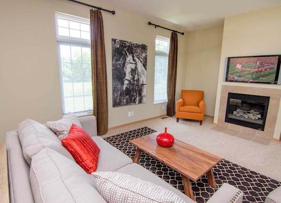 a living room with a white couch and a fireplace