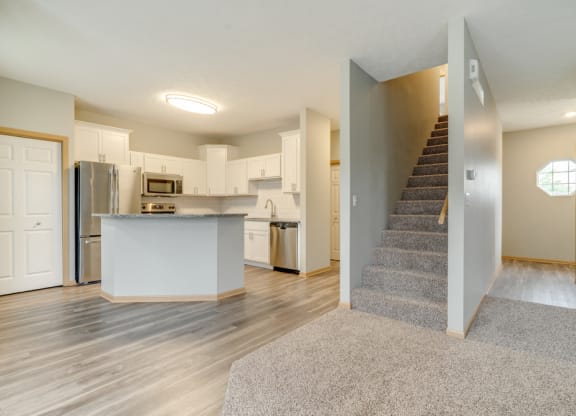 Living and dinning room area with view of kitchen and stairs to the second floor at Cascade Pines Duplex and Townhomes