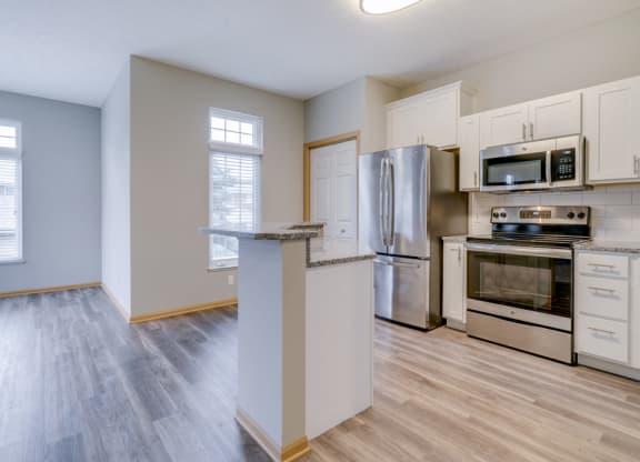 Kitchen with stainless steel appliances and island at Cascade Pines duplex and townhomes