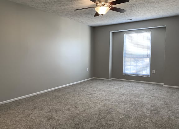 Carpeted bedroom with walk in closet at Eagle Run Apartments in Omaha Nebraska