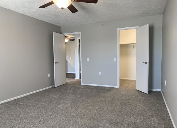 Carpeted bedroom with walk in closet at Eagle Run Apartments in Omaha Nebraska