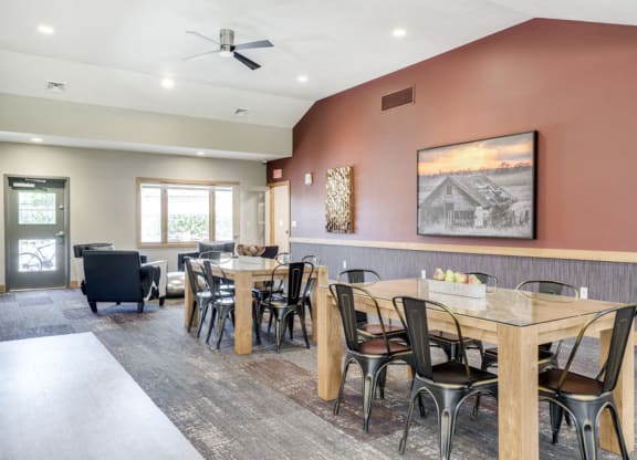 Tables and seating in the clubhouse at Fountain Glen Apartments