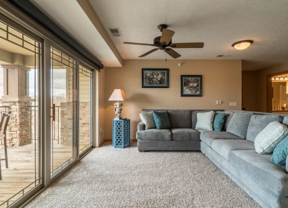 a living room with a couch and a ceiling fan