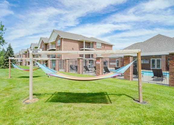 a pair of hammocks near the community clubhouse and pool