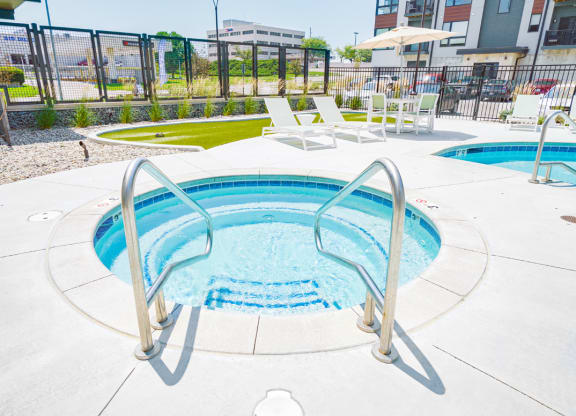 a relaxing in-ground hot tub at the Haven at Uptown apartments