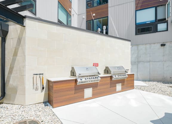 two poolside grills outside of Haven at Uptown apartments