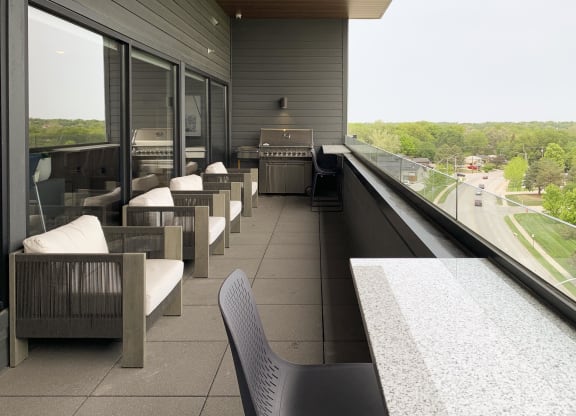 the sky deck with a grill and chairs over looking the city of lincoln