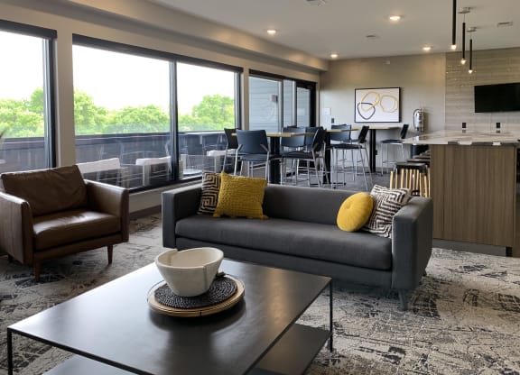 the sky lounge filled with furniture and a large window out looking the deck