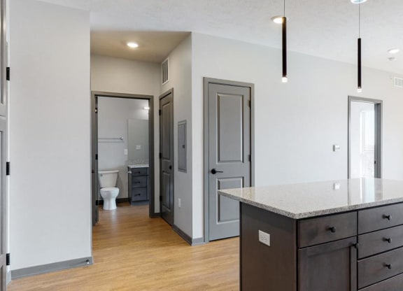 View of kitchen island and hallway leading to the bathroom in the Bliss floor plan at Haven at Uptown in Lincoln, NE