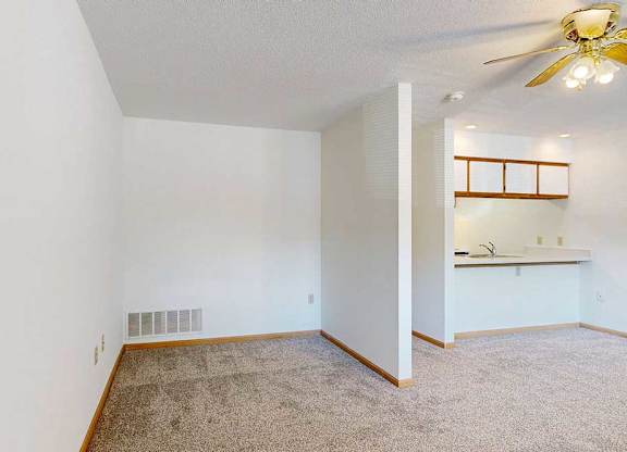 Sleeping area with partial view of kitchen and open layout