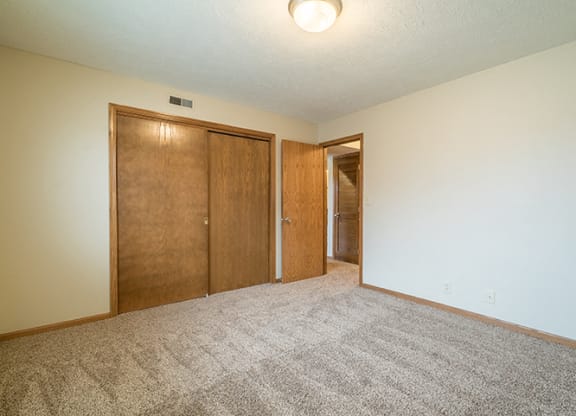 Spacious bedroom with closet space at Fountain Glen Apartments