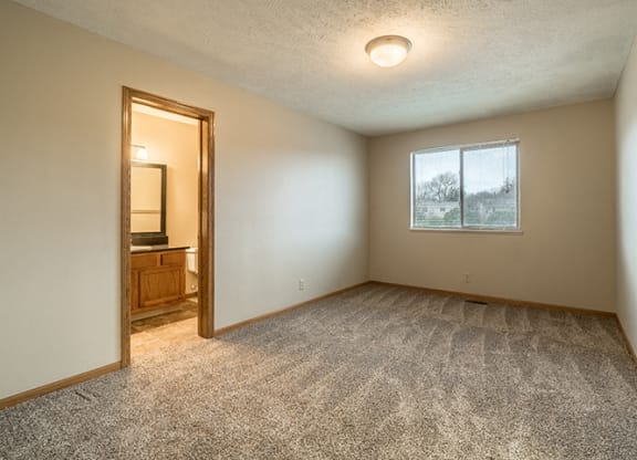 Bedroom with attached bathroom at Fountain Glen Apartments