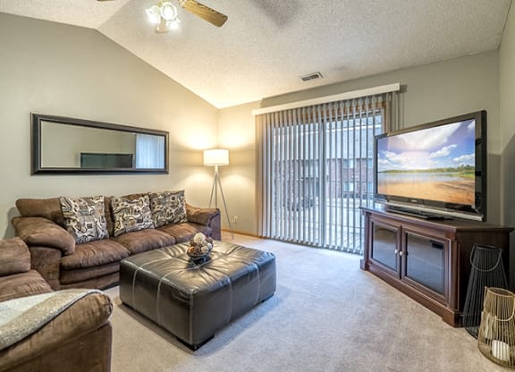 Living room with large sliding doors at Fountain Glen Apartments
