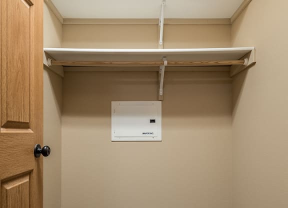 a large walk-in closet with built-in shelving and hanging space