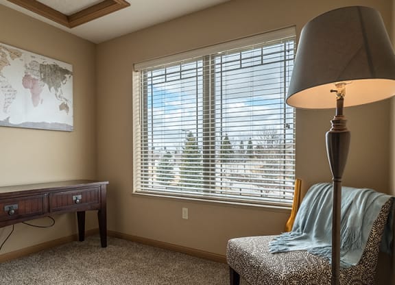a den space with a reading chair and a desk