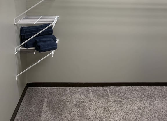 Large walk in closet with shelves for clothing storage in a 3 bedroom villa
