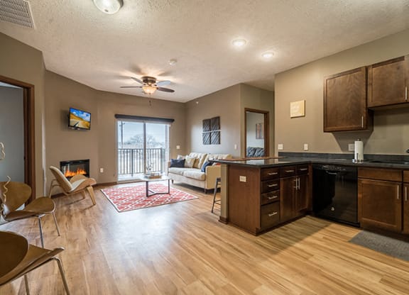 Kitchen and living room with hardwood-like flooring at the Villas of Omaha Butler Ridge in Omaha NE