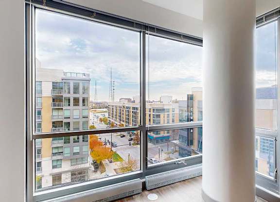a floor to ceiling window with a view of midtown crossing from the living room of the 2-bedroom Tuscon