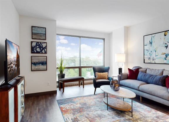 Enjoy the scenic views from the floor-to-ceiling windows in the living area of a 1 bedroom floor plan at Midtown Crossing Apartments Omaha