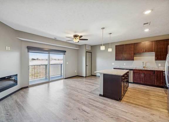 A spacious living room with a fireplace and sliding glass doors.