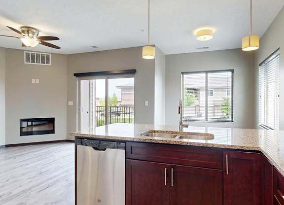 A view of the living room and dining area from the kitchen peninsula.