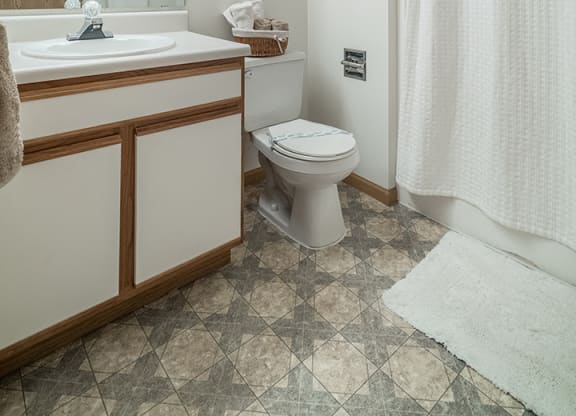 Bathroom with bright lighting and vanity at The Northbrook Apartment Homes, Lincoln, NE