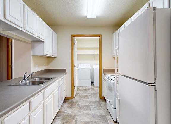 A kitchen with white appliances and cabinets.