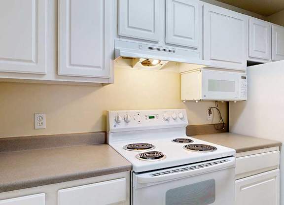 stove and oven in a kitchen with white cabinets