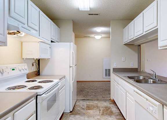 a kitchen with white appliances and cabinets