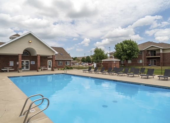 Large outdoor pool with lounge chairs at The Northbrook Apartments
