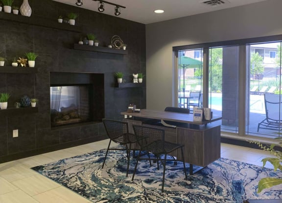 front desk with two chairs and a large window in the clubhouse at north pointe villas in lincoln