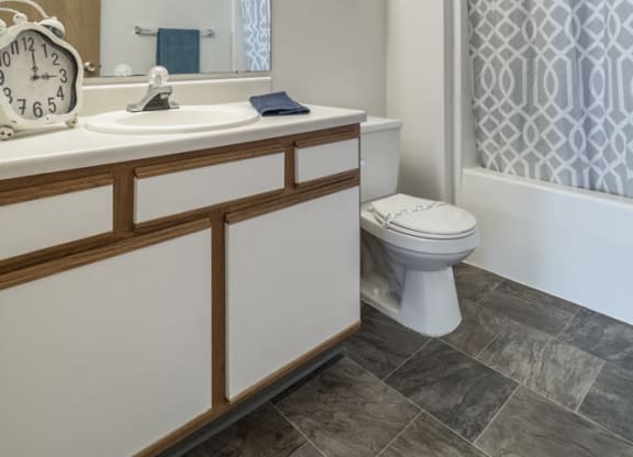 Attached bathroom with cabinet storage space and new flooring at Northridge Heights