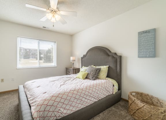 Bedroom with ceiling fan and natural light at Northridge Heights in north Lincoln