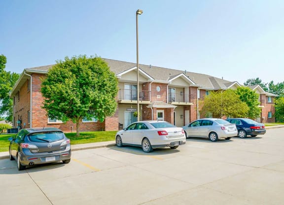 Parking lot with cars and multi-story apartment buildings