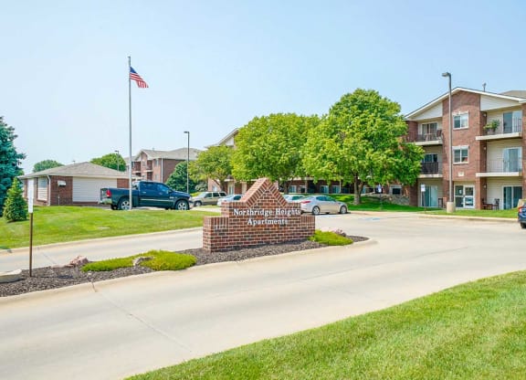 Community sign with well-maintained landscaping at the entrance