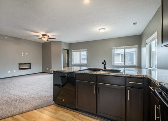 Interiors- A kitchen that opens up to a large living space at the Villas of Omaha at Butler Ridge in Omaha Nebraska