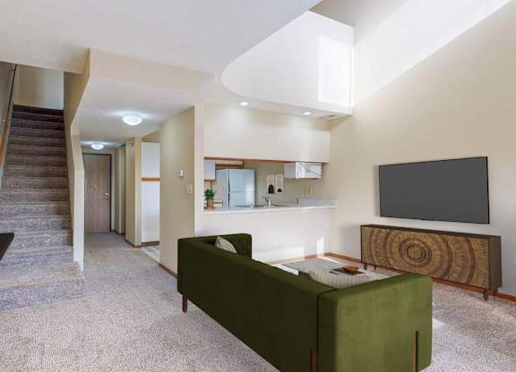 A living room with a green couch and a television.